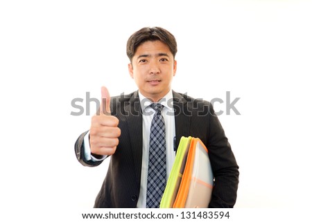 Happy business man showing thumb's up sign