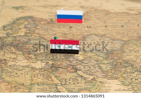 Flags of Russia and Syria on the world map. Conceptual photo, politics and world order