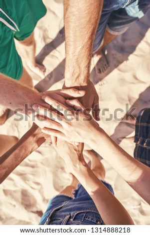 Close up of hands holding together at the beach
