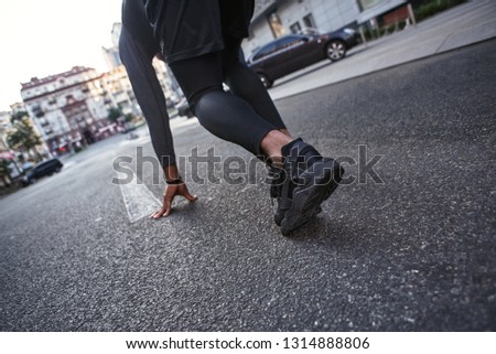 Ready to go Close-up photo of sportsman preparing for start in running position. Sport motivation concept.