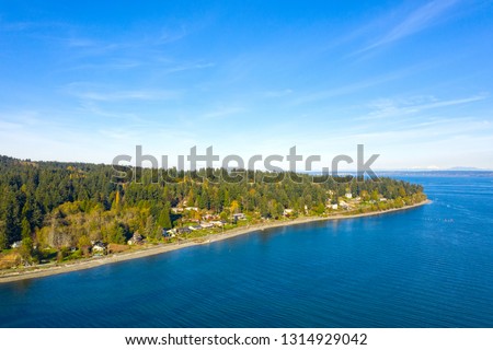 Bainbridge Island Coastline Beach Waterfront Panoramic Landscape Forest and Mountains Royalty-Free Stock Photo #1314929042