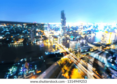 Blur bokeh night light city downtown over train track motion, abstract background