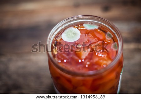 Mold on the jar of jam. Quince preserves with botulism spores. Royalty-Free Stock Photo #1314956189