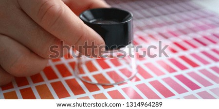 Employee refueling cartridge service holds magnifying glass in hand. Color print of statistics offset organization gives customer an order products for distribution during promotion concept