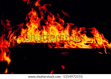 Blurred Bright Red and Orange Firestorm Texture on Black Background (Real Fire), shot of flying fire sparks