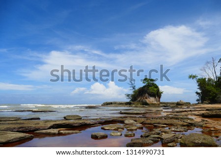 photo picture of a beautiful sea and ocean view with a natural background of rocks, forests and mountains.