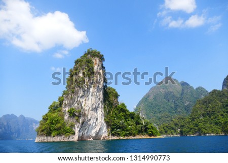 photo picture of a beautiful sea and ocean view with a natural background of rocks, forests and mountains.
