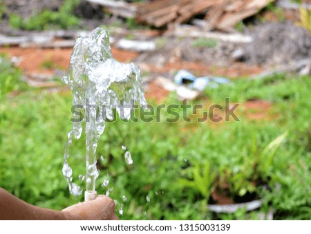   water flowing out of the rubber hose
