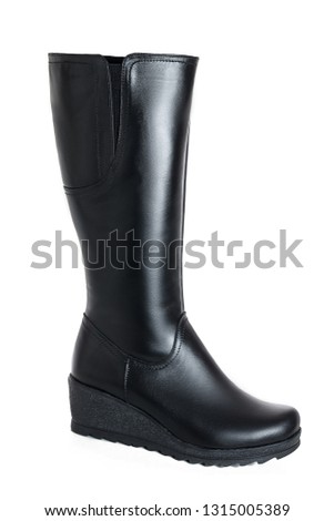 Female black leather boot on a white isolated background. Women's winter shoes