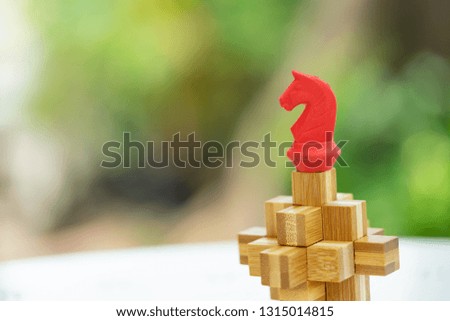 Red chess piece on wooden puzzle as background, success, dealing, business planner, forecast concept.