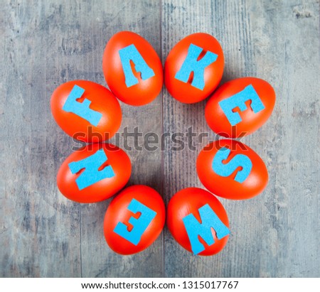 Birth of the fake news: eggs with "fake news" words on wooden background