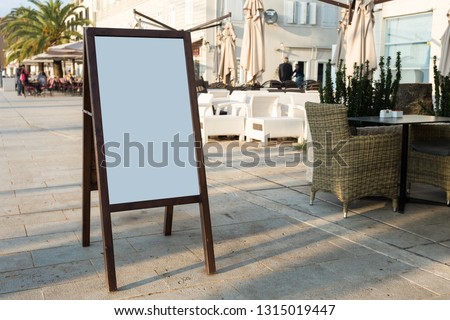 Blank white outdoor advertising stand, sandwich board mock up template. Clear street signage board placed inside modern building. Urban city, shopping center environment