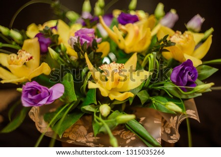 A bouquet of yellow orchids in a tree box