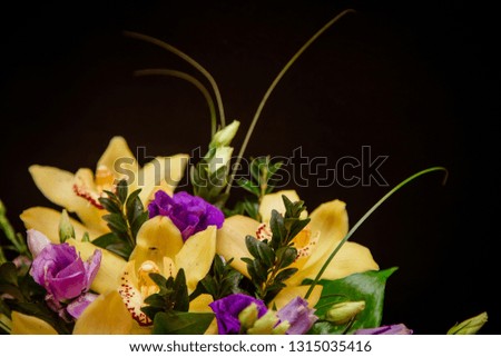 A bouquet of yellow orchids in a tree box