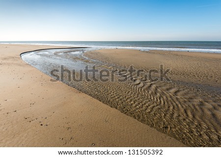Flowing water at low tide on the Dutch North Sea coast