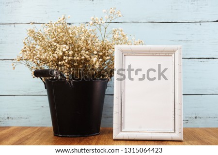 space photo frame with dried flower in metal flower pot