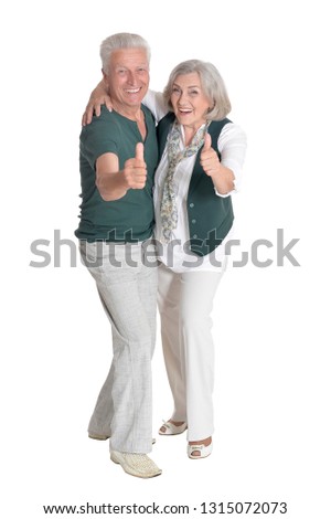 Portrait of senior couple with thumbs up isolated