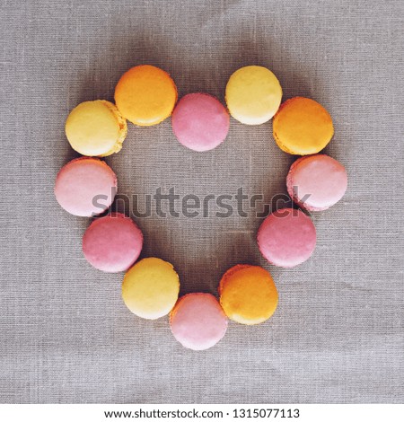Heart shape made of sweet colorful macarons