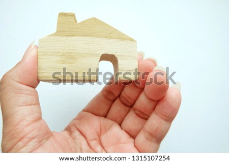 Close up of mini house on woman hand.