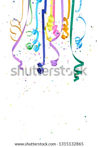 Serpentines and colorful confetti falling and depended on white background