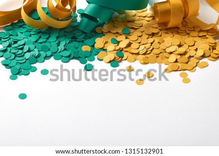 Carnival background with confetti and green and yellow serpentine spaced on white background