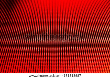 Red dot lights arranged on a video screen matrix. Shallow depth of field for a blurred effect.