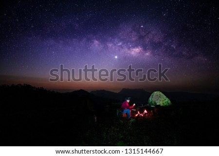 Silhouette of a man in a camping And the beauty of the Milky Way at Doi Luang, Chiang Dao District, Chiang Mai Province
