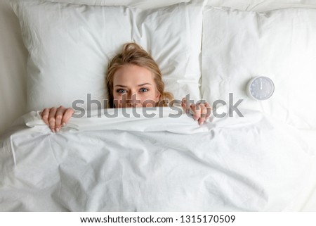 attractive girl hiding her face under the blanket, top view photo,Sunday, Saturday