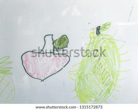 Kids drawing a cartoon picture on the paper with color pencil.