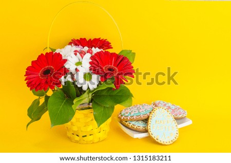 Beautiful bouquet of flowers and homemade gingerbread for celebration of Easter. Studio Photo