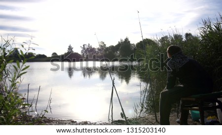 man fishing on the lake
