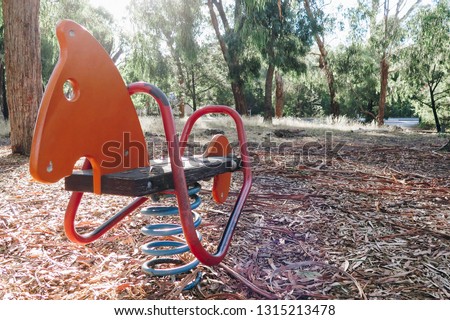 Orange spring horse at playground