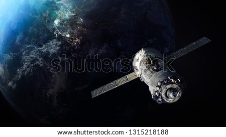 Spaceship and Earth on the background. Voyage into the solar system. Elements of this image furnished by NASA