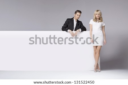 Elegant couple next to white board