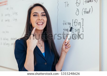 English lesson Teacher shows how to pronounce the sounds Royalty-Free Stock Photo #1315248626