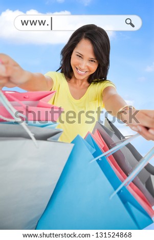 Woman showing her shopping bags under address bar on blue sky background