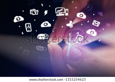 Finger touching tablet with white drawn application icons and dark background