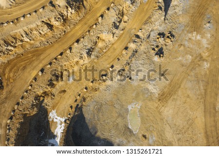 Aerial view of opencast mining quarry with lots of machinery. Industrial place view from above. Photo captured with drone.