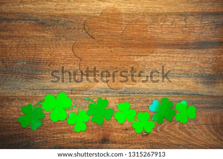 Wooden background with trefoil, shamrock. The symbol of St. Patrick's Day