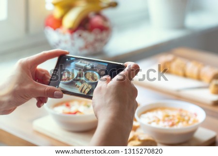 Closeup how womans hands taking photo of vegetarian food at home