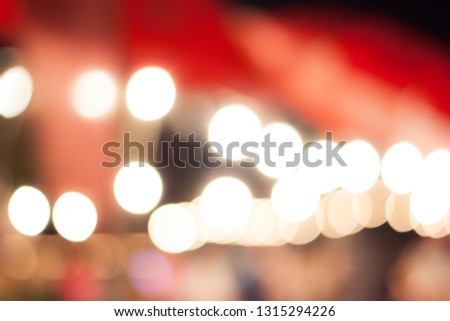 Abstract blur image of Night market on street for background usage. (vintage tone)