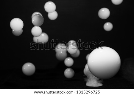 white soap bubbles filled with smoke on dark background