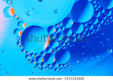 Abstract background with colorful gradient colors. Oil drops in water abstract psychedelic pattern image. Blue colored abstract pattern