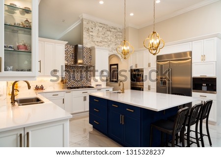 Beautiful luxury home kitchen with white cabinets. Royalty-Free Stock Photo #1315328237
