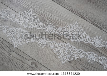 wooden background with lace ribbon. Happy womans day. The texture of lace on wooden background. 