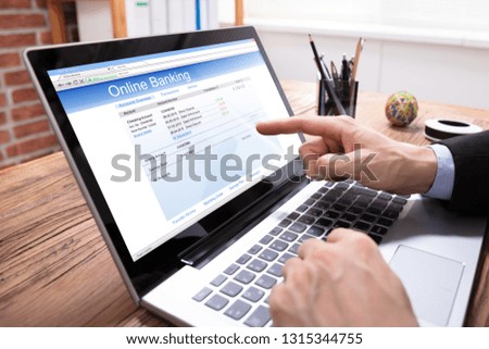 Close-up Of A Businessperson Showing Online Banking Application On Laptop Screen
