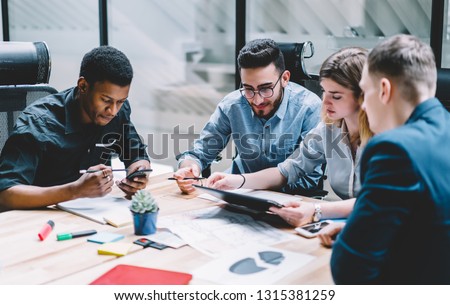 Group of diversity people searching information for provide ideas in new startup project using touch pad during brainstorming, collaboration and cooperation.Four colleagues sharing opinions at meeting Royalty-Free Stock Photo #1315381259