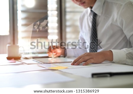Businessman working with analysis data on digital tablet.