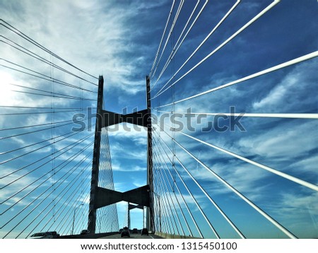 Cable bridge across St.Johns River on the blue sky white clouds and the sunlight, Winter in Jacksonville, Florida USA.