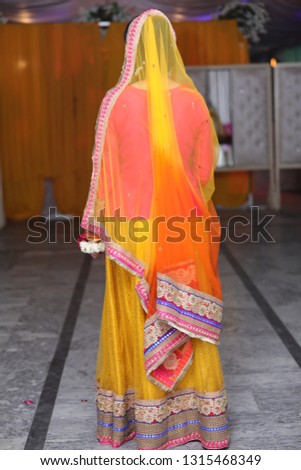 Young Bride's portrait from backside showing her complete getup and dress with beautiful environment